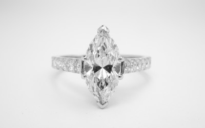 Platinum single stone 1.51ct. 'D' colour Marquise diamond ring with round brilliant cut diamonds cut down set in shoulders.