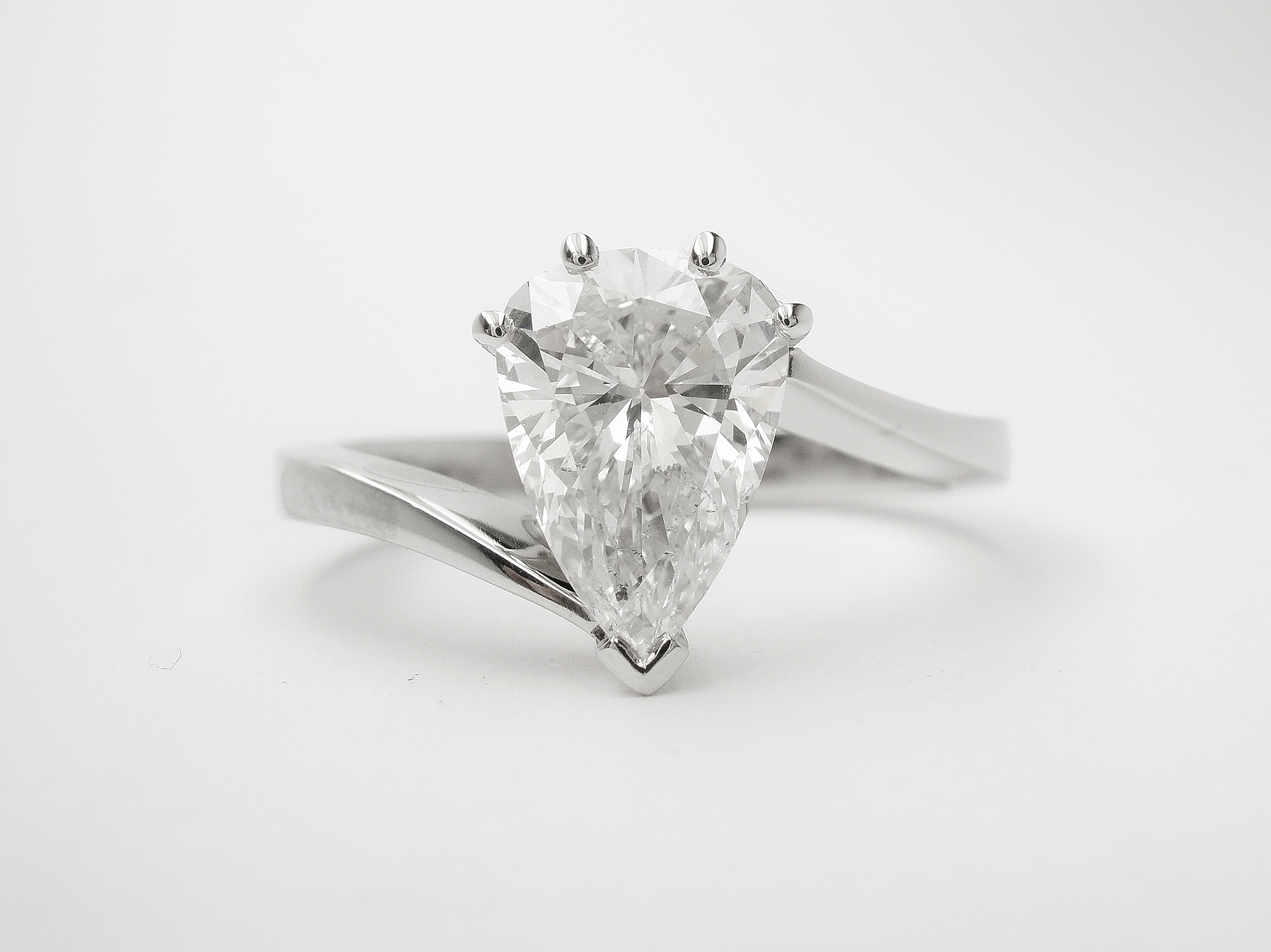 Pear shaped diamond of 1.10cts. mounted in a platinum cross-over ring mount.