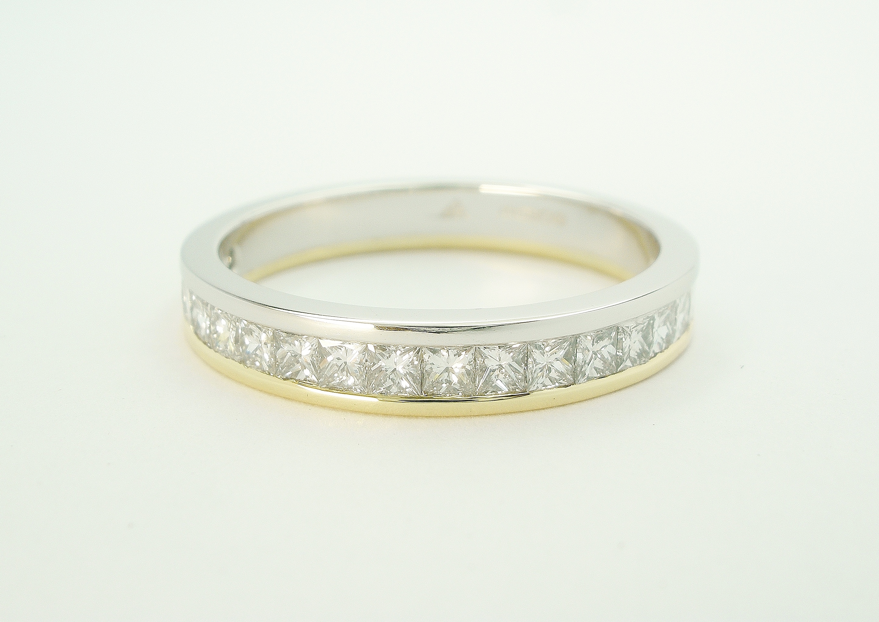 Princess cut diamond platinum & 18ct. yellow gold channel set wedding ring to 55% cover.