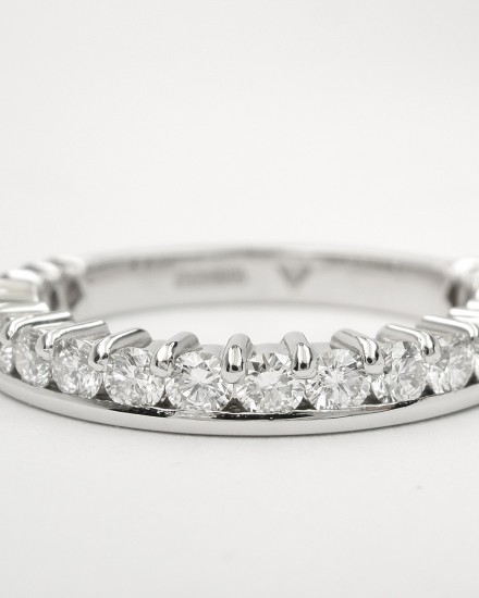 Platinum part channel set round brilliant cut diamond wedding ring set to 65%.