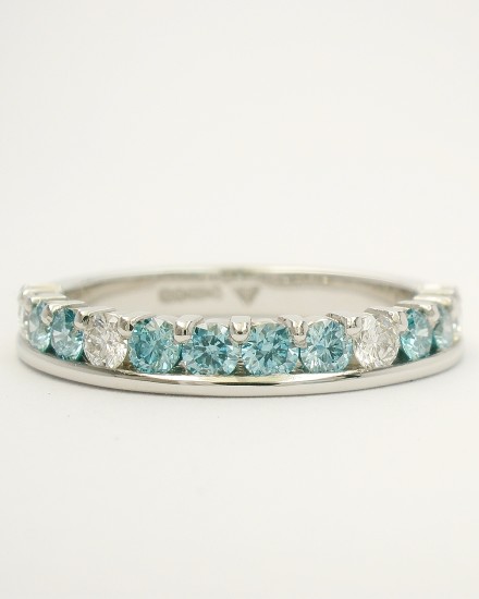 Platinum part channel set round brilliant cut sky blue diamond & white diamond wedding ring set to 55% cover.