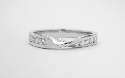 Diamond set 'twist' palladium wedding ring shaped to fit with a single stone diamond ring with pear diamond shoulders. This will fit with a single stone ring.