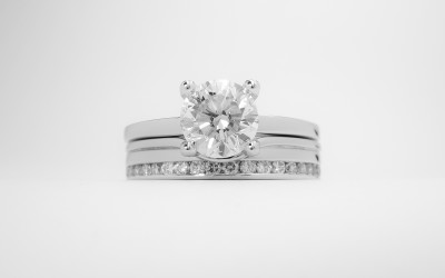 18ct. white gold 'Off-set' diamond wedding ring shaped to fit with a single stone straight diamond engagement ring.