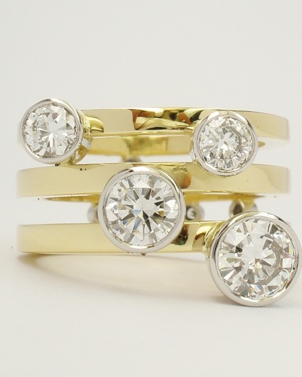 Round brilliant cut diamond 4 stone platinum rub-over set ring with a triple parallel 18ct yellow gold banded ring shank set with small diamonds on reverse side of bands. Ideal for right hand.