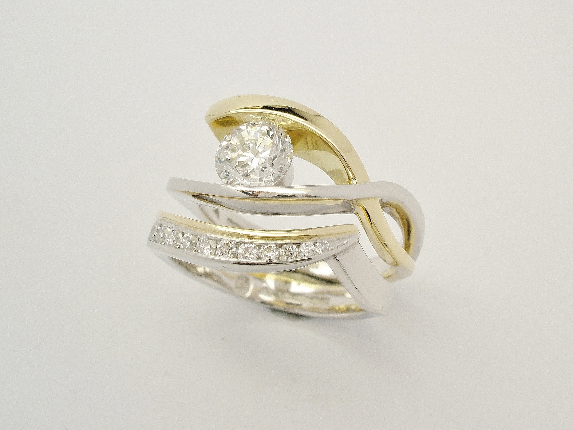 18ct. yellow gold & platinum wedding ring set with tapering sized diamonds around the curve shaped to fit single stone open cross-over engagement ring.