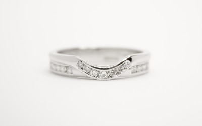 'Collar style' diamond set platinum wedding ring shaped to fit with a single stone straight diamond engagement ring.