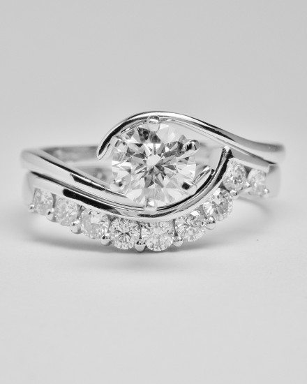 Part channel & wire set diamond wedding ring mounted in platinum & shaped to fit a single stone cross-over diamond engagement ring.