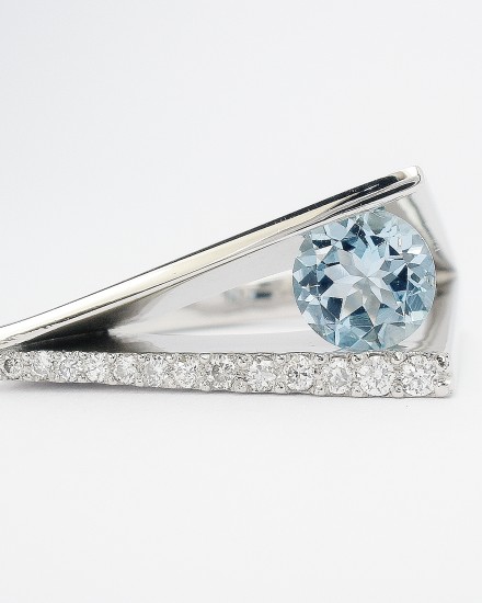 Round aquamarine & diamond 'Wedge' shaped, plateau, square sectioned ring mounted in palladium.