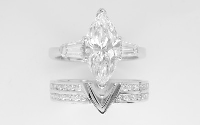Double channel set round brilliant cut platinum wedding ring shaped with a fine 'V'shaped panel in centre to allow a diamond marquise ring with baguette shoulders to fit in.