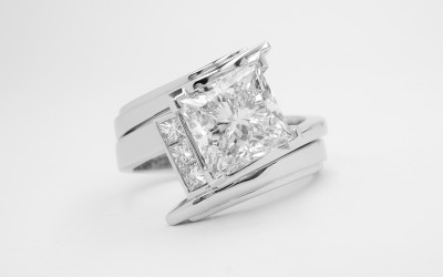Zig-zag' platinum wedding ring shaped to fit a princess cut diamond cross-over engagement ring set with 3 princess cut diamonds.