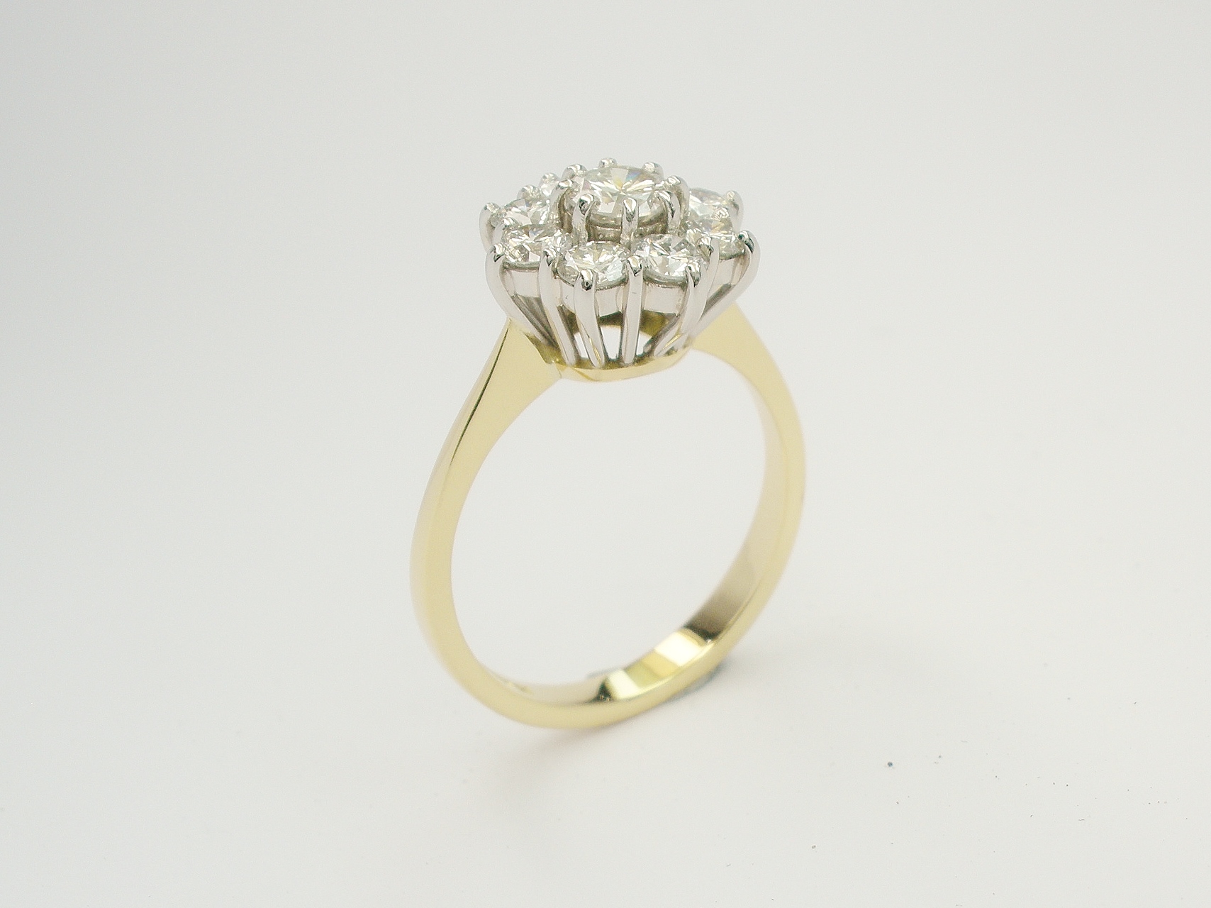 My remodel of 9 stone round brilliant cut diamond cluster in 18ct. yellow gold & platinum.