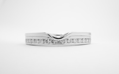 18ct. white gold wedding ring with applied wire shaped to fit a single stone pear diamond engagement ring with diamonds off-set along back edge.