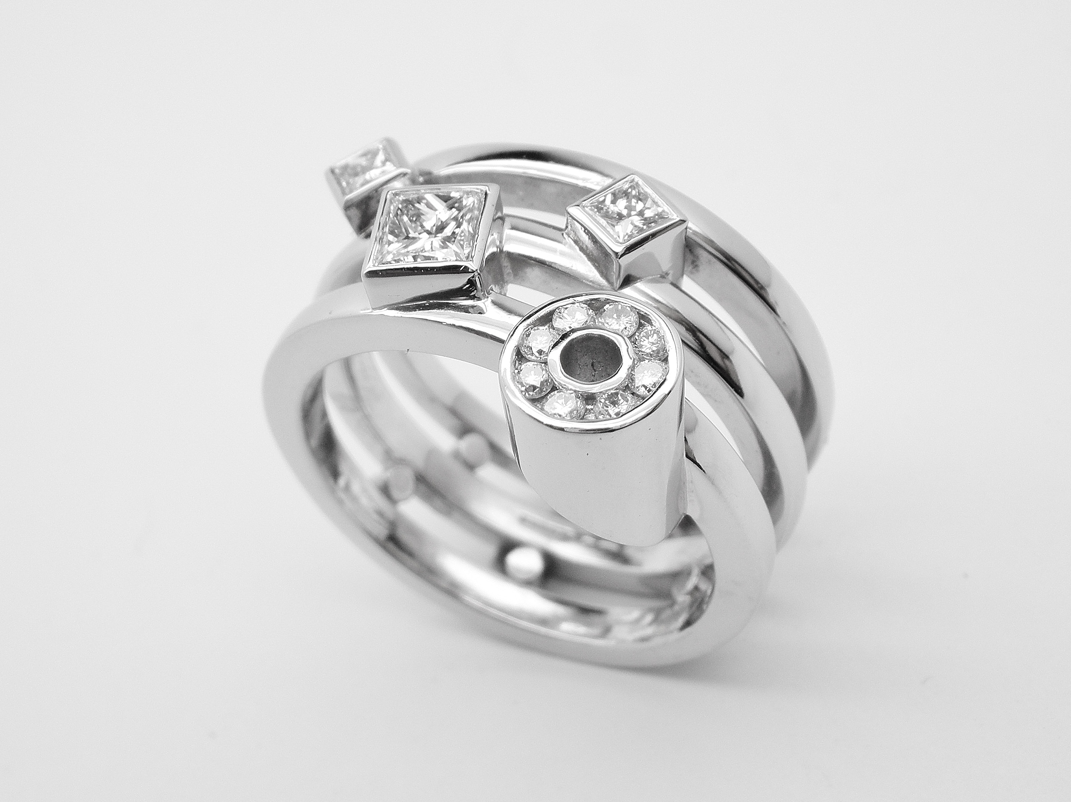 Diamonds remodelled into a triple banded ring, palladium outer rings with the plain platinum wedding ring in the centre & the diamonds rub-over set in platinum.