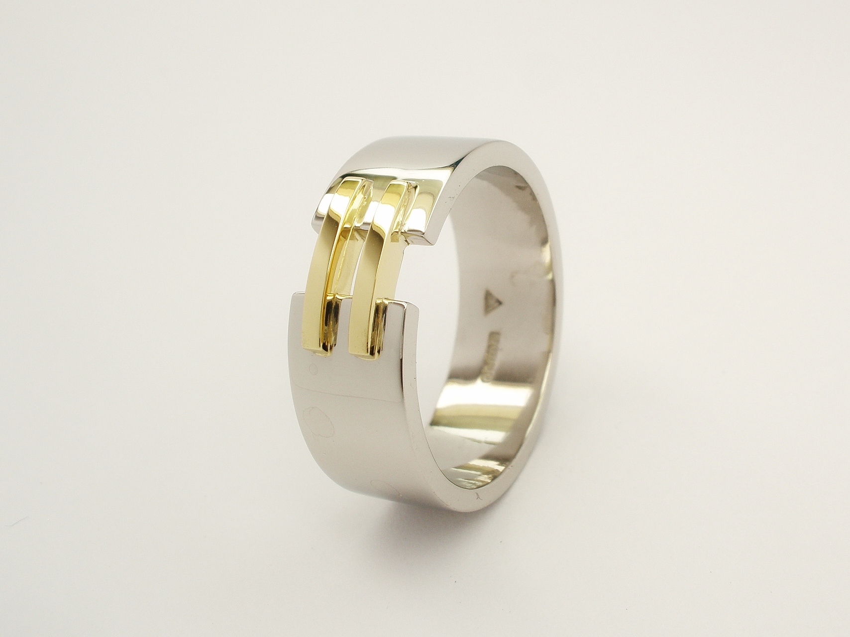 Gents palladium wedding ring with a pair of 18ct. yellow gold 'tram line' wires inlayed & bridging a gap across the top.