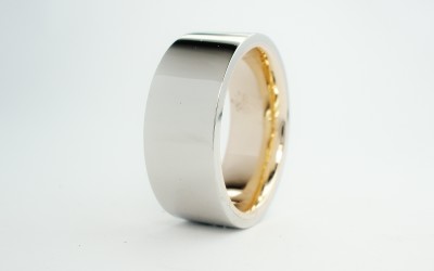 The gentleman had his fatherâ€™s 9ct. yellow gold wedding ring which he wished incorporated into his wedding ring which was to be visually white metal. The thickness and width of the fatherâ€™s ring allowed Alan to size the fathers ring to fit the client then overlay a palladium band. The 9ct yellow band is only visible when the ring is not being worn.