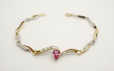 Pear shaped pink sapphire and diamond set 18ct. yellow gold and palladium bespoke bracelet.