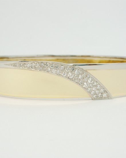 9ct yellow gold and palladium hand crafted hinged bangle with a central cascade shaped palladium panel Pave set with diamonds.