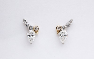 Platinum & 18ct. yellow gold pear shaped diamond &round brilliant cut diamond 5 stone stud earrings.