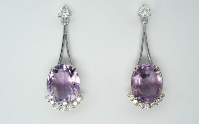 Oval amethyst and round brilliant cut diamond wishbone split wire 'pendulum' style drop earrings.
