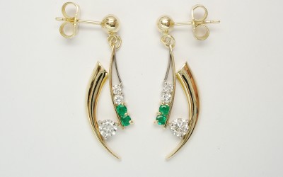 Pair of Horn shaped 9ct. yellow gold and palladium wire earrings set with diamonds & emeralds.