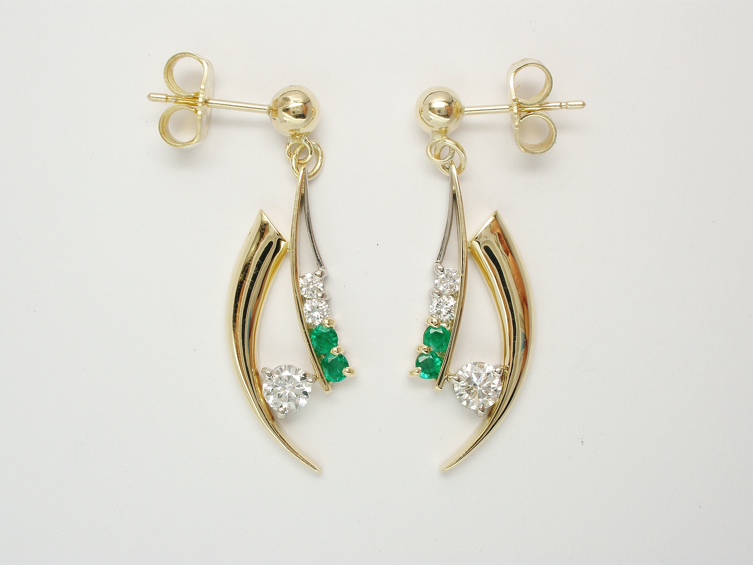 Pair of Horn shaped 9ct. yellow gold and palladium wire earrings set with diamonds & emeralds.