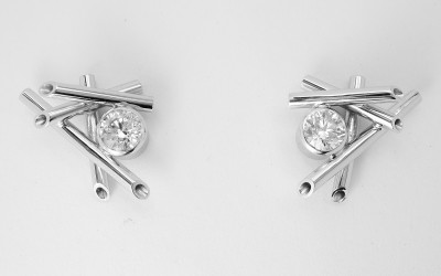 Single stone round brilliant cut diamond 'chop stick' style 18ct. white gold ear studs.
