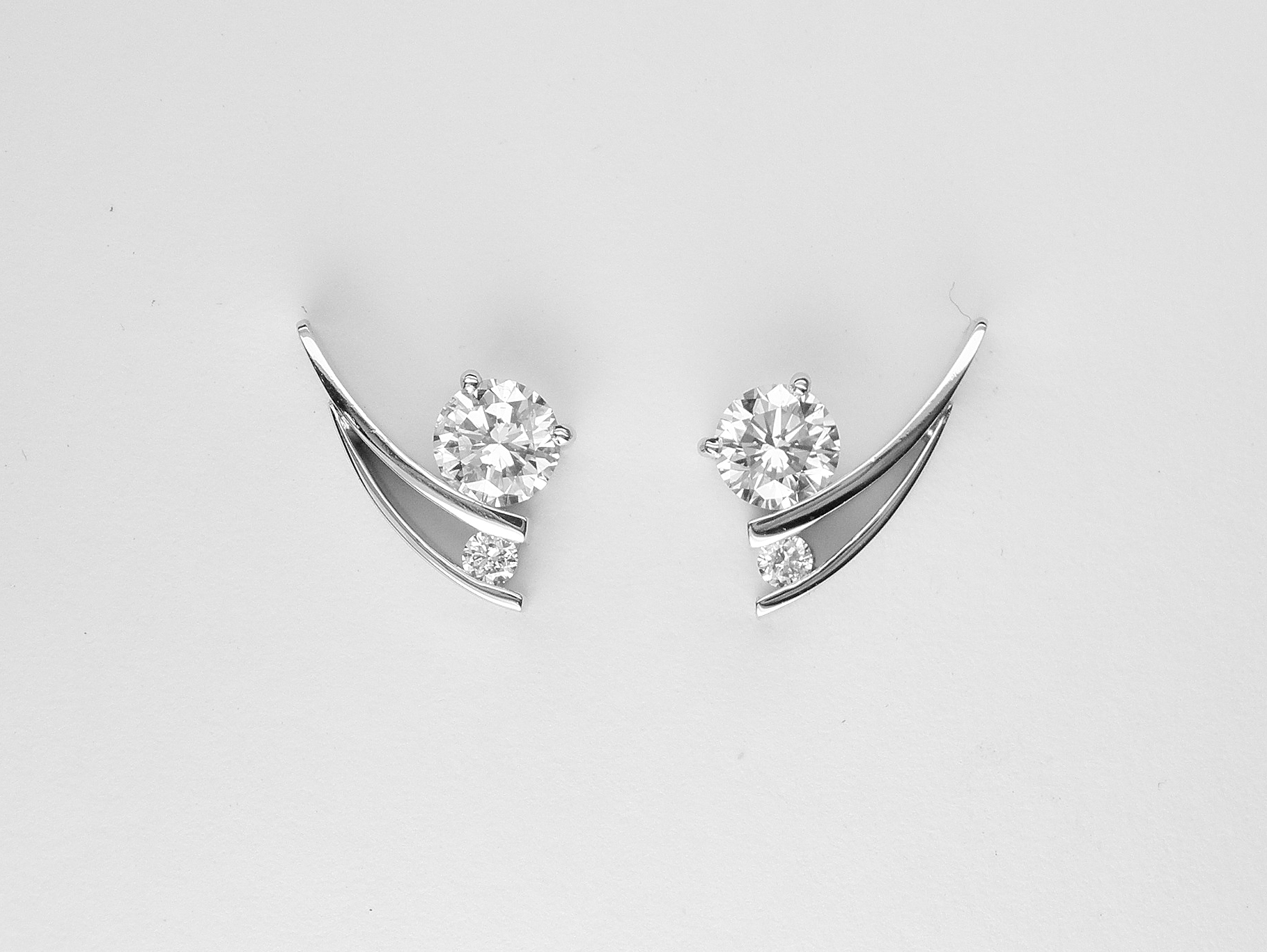 'Tick' style Platinum & palladium set 2 stone round brilliant cut diamond stud earrings.