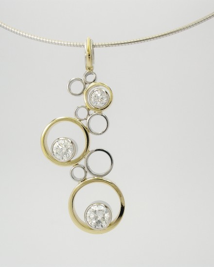 Platinum & 18ct. yellow gold tumbling rings pendant set with 3 round brilliant cut diamonds.