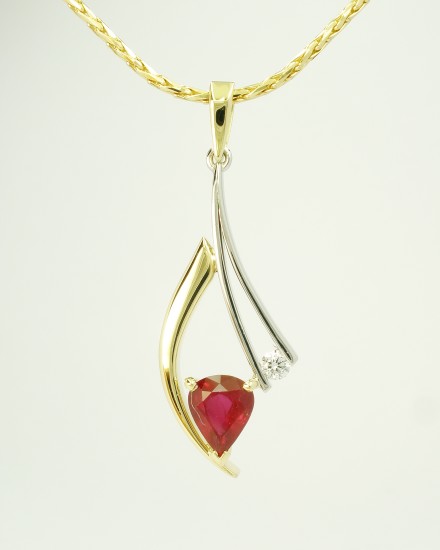 Tear drop shaped ruby and round brilliant cut diamond 18ct. yellow gold horn and fine platinum wire pendant.