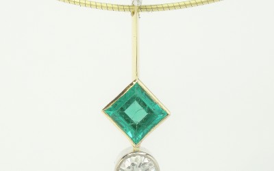 Square cut emerald and round brilliant cut diamond platinum & 18ct. yellow gold 3 stone pendulum style pendant.
