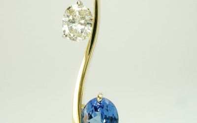 Oval sapphire & oval diamond 2 stone 'S' shaped 18ct. yellow gold pendulum style pendant.