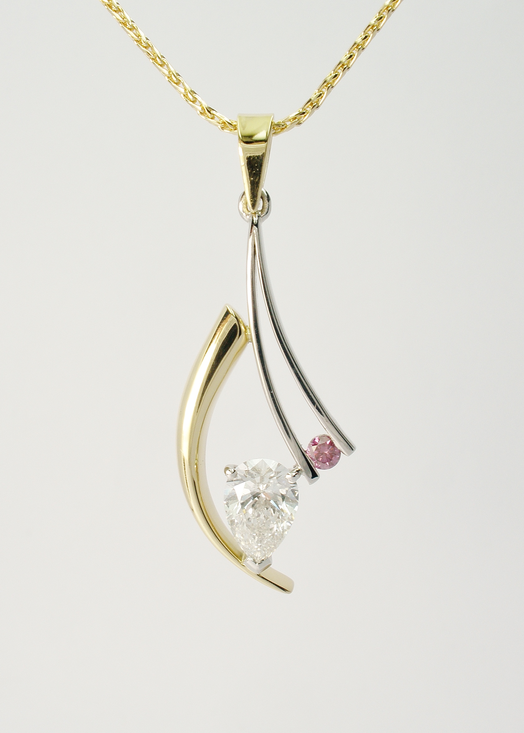 'D' coloured white pear diamond and round purple diamond pendant set within an 18ct. yellow gold horn shaped wire & fine platinum wires.