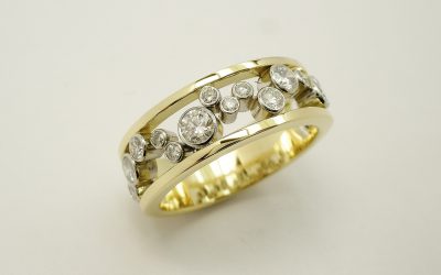 Round brilliant cut diamond 'Bubbles' Ring mounted in 18ct yellow gold and platinum.