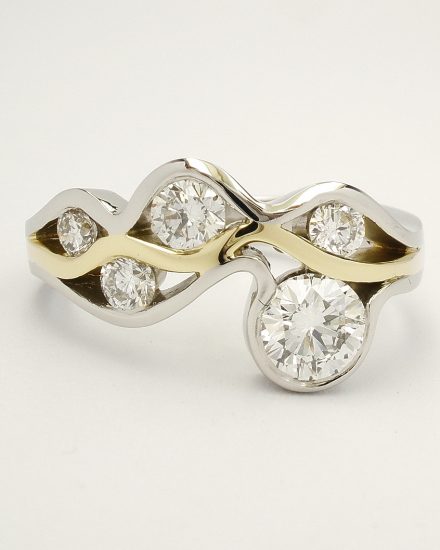 Round brilliant cut diamond 'Wave' ring mounted in Platinum and 18ct. yellow gold.