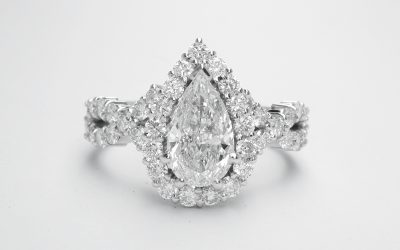 Pear shaped halo cluster ring with centre 0.70ct. 'D'colour pear diamond & criss-cross diamond shoulders set in platinum.