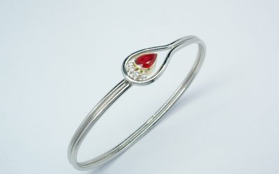 Pear shaped ruby & 4 brilliant cut diamond palladium,18ct. yellow gold & platinum loop style bangle.