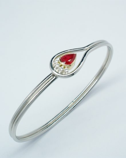 Pear shaped ruby & 4 brilliant cut diamond palladium,18ct. yellow gold & platinum loop style bangle.