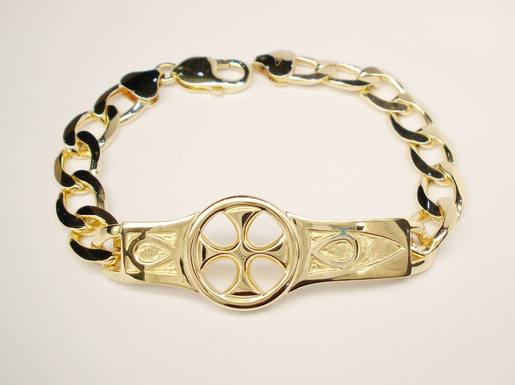 A 9ct. yellow gold bracelet with a hand carved 'Iona' style centre panel.