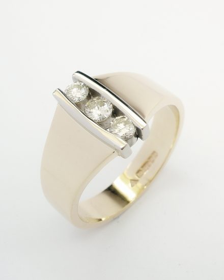 3 stone round brilliant cut diamond vertically channel set 18ct. yellow gold and platinum ring.