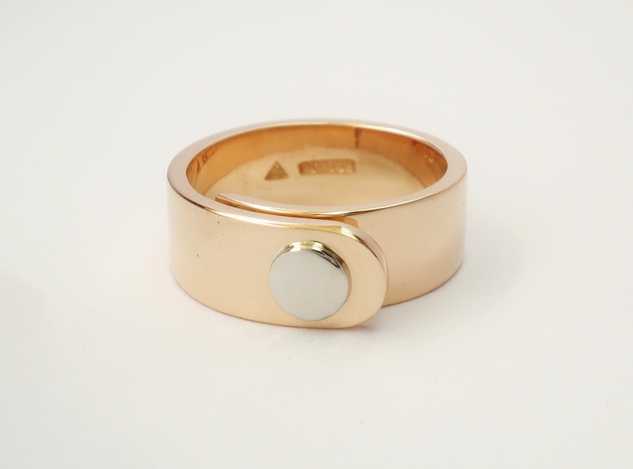 9ct. Red gold (also known as pink gold or rose gold) 'overlap' ring with round palladium disc part inlayed on top tongue in place of diamond.