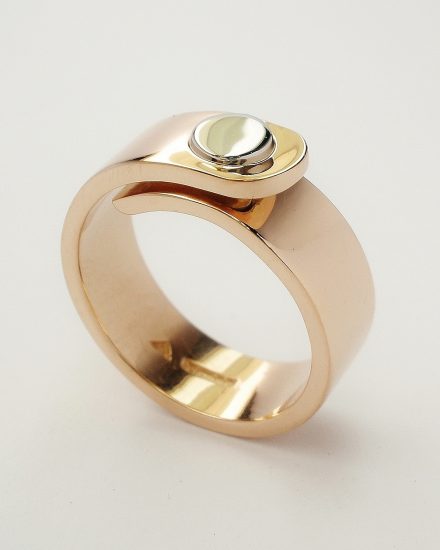 9ct. Red gold (also known as pink gold or rose gold) 'overlap' ring with round palladium disc part inlayed on top tongue in place of diamond.
