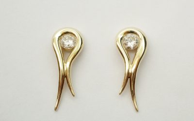 A pair of single stone diamond & 18ct. yellow gold tapered loop earrings.