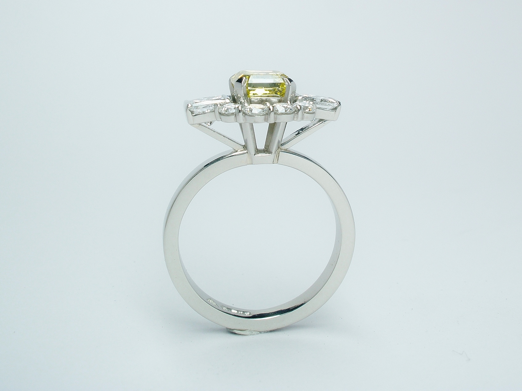 Canary yellow Asscher cut diamond (1.20cts.), white princess cut and round brilliant cut diamond 'Halo' cluster ring mounted in platinum.