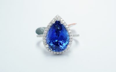 18ct white gold vivid blue-violet eye flawless 5.73ct. tanzanite and diamond (0.36ct) halo ring.