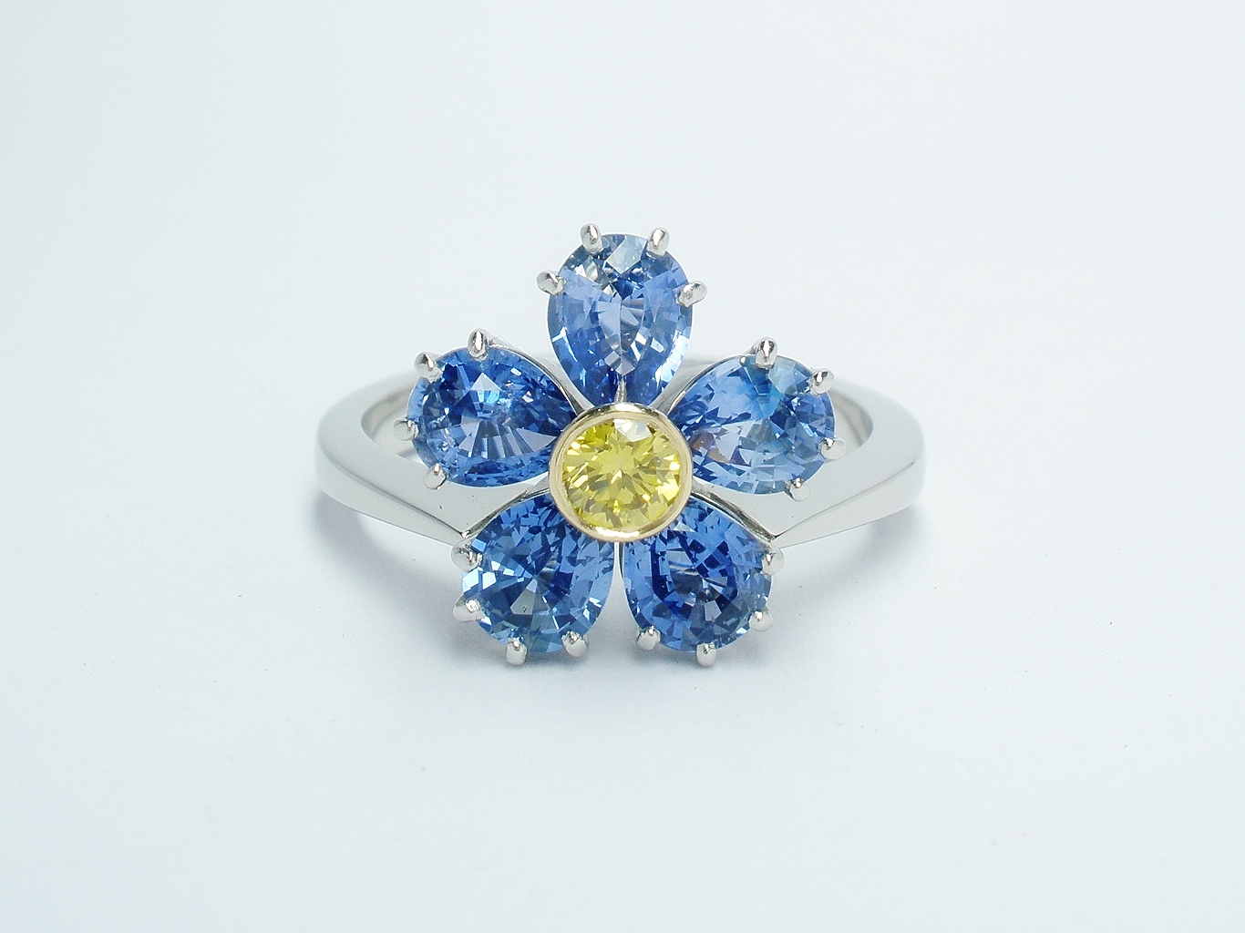 6 pear shaped sapphire and HTHP treated canary yellow diamond ring mounted in platinum & 18ct. yellow gold to mimic a Forget Me Not.