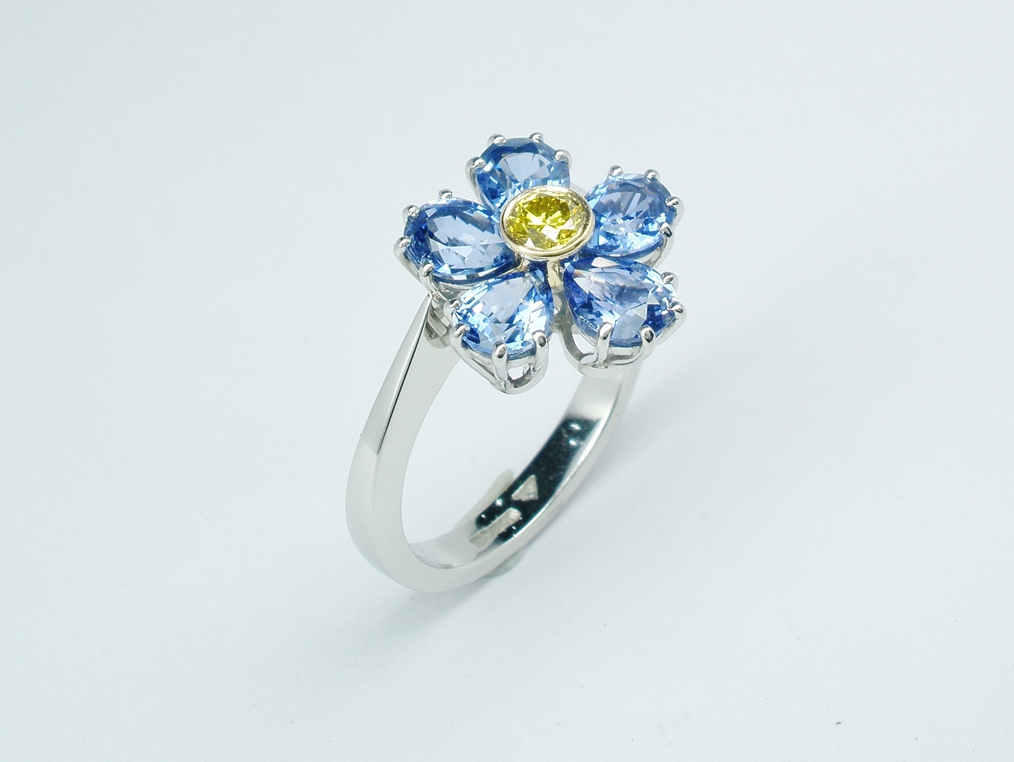 6 pear shaped sapphire and HTHP treated canary yellow diamond ring mounted in platinum & 18ct. yellow gold to mimic a Forget Me Not.