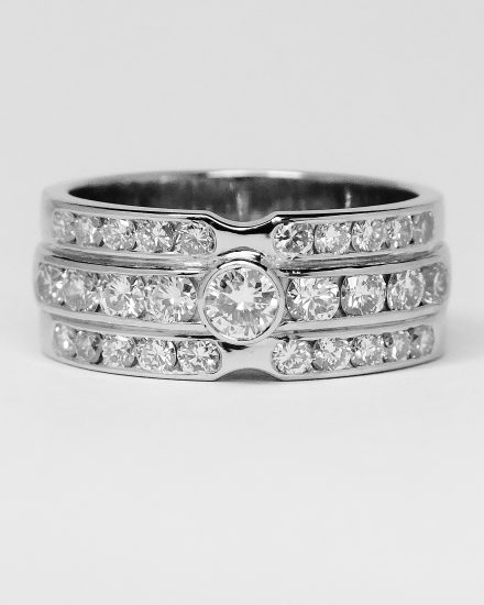 Brilliant cut diamond and round sapphire triple channel set ring mounted in palladium & platinum.