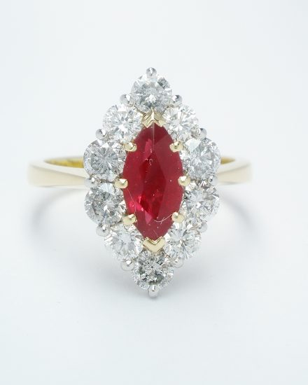 Marquise ruby and round brilliant cut diamond cluster ring mounted in 18ct. yellow gold and platinum.