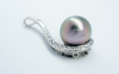 Black Tahitian pearl and round brilliant cut diamond pendant mounted in palladium.
