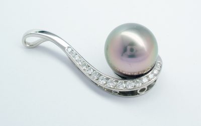 Black Tahitian pearl and round brilliant cut diamond pendant mounted in palladium.